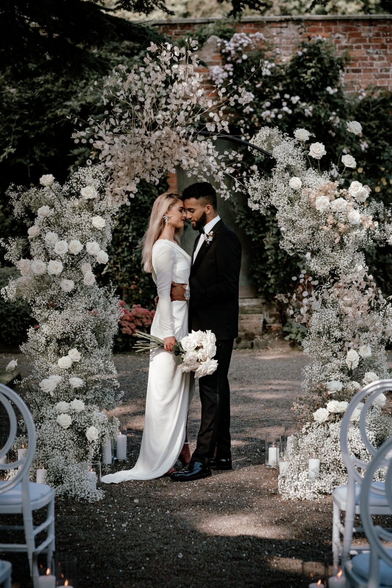 white U arch white roses and baby's breath wedding arch