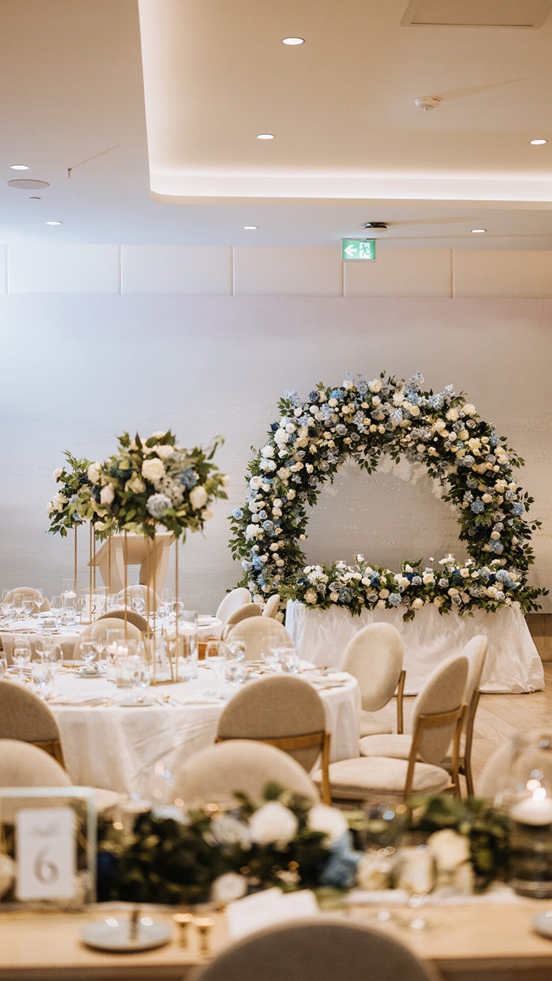 White/blue arch shots/floral centerpieces