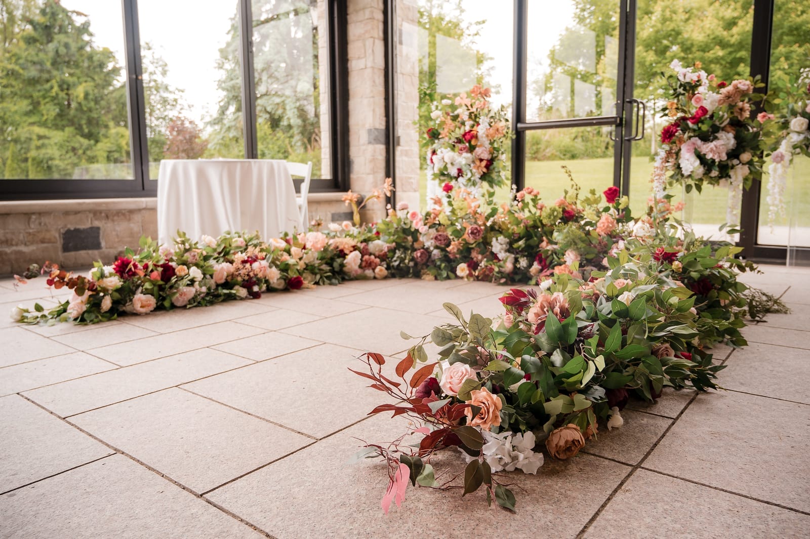 Floral arch used as an alter on the floor
