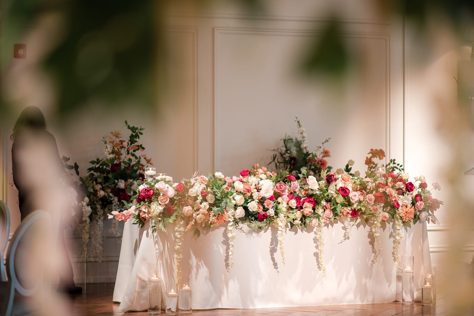 Cascading flowers on the bride and groom's table - wedding at The Arlington Estate