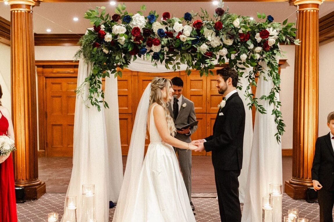 Noelle and partner under the chuppah at the alter - One King West Hotel & Residence