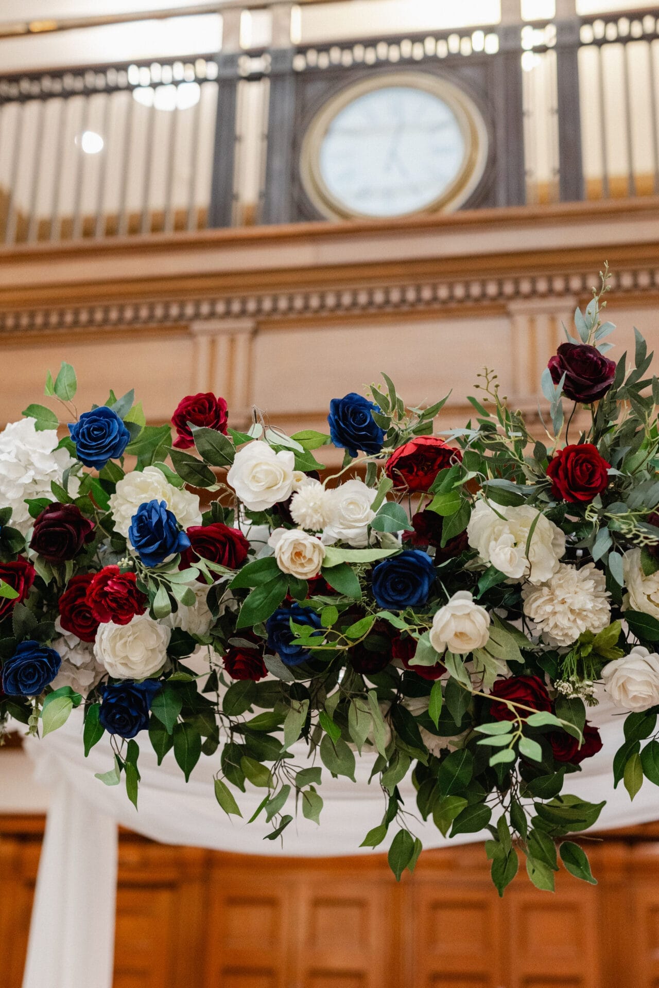 Close-up of red, blue, and white faux flowers on the chuppah - One King West Hotel & Residence
