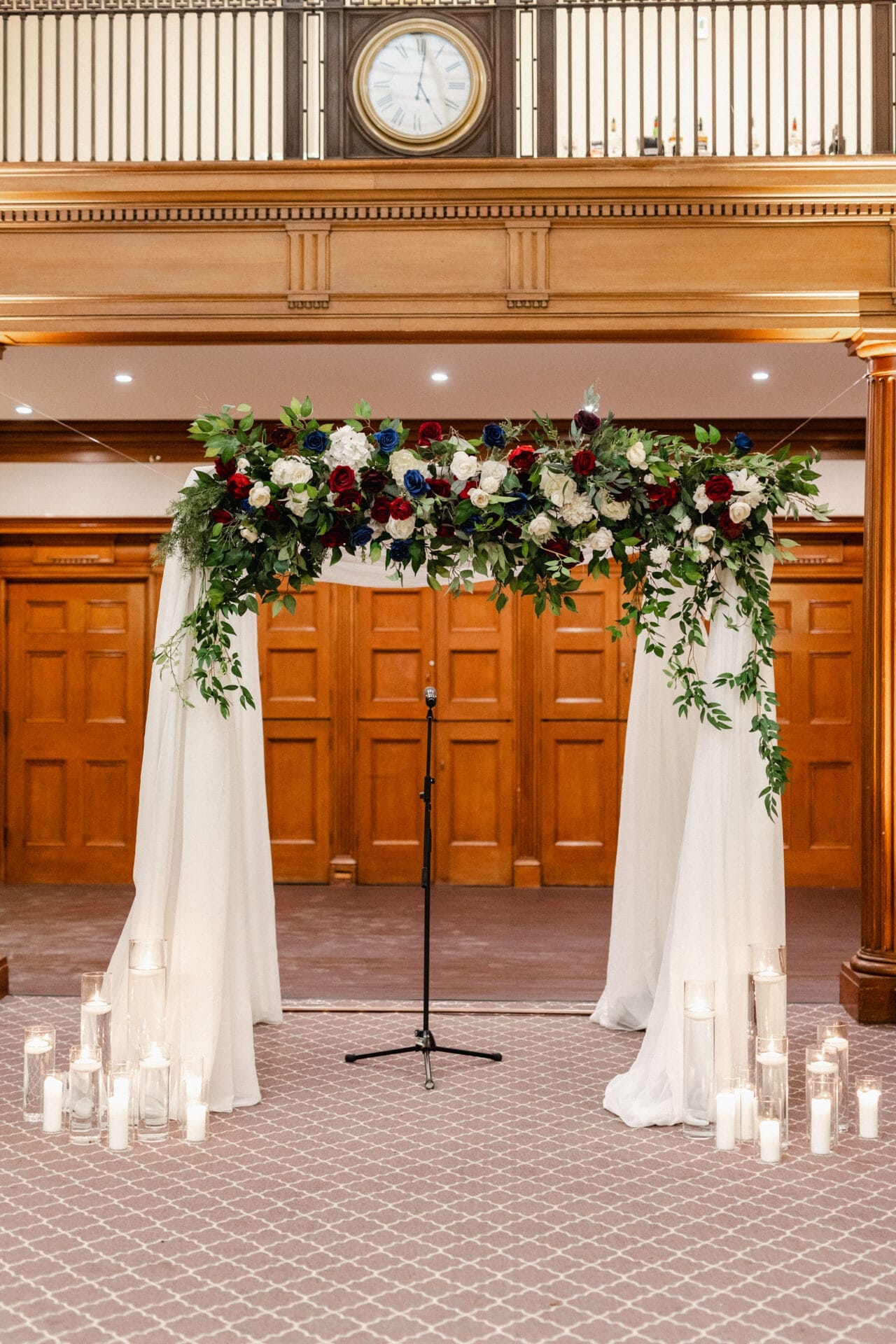 Chuppah with blue, white, and red faux flowers - One King West Hotel & Residence